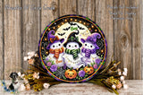 A Halloween-themed wreath with three ghostly snowmen wearing purple and green hats, surrounded by pumpkins and flowers, set against a wooden background.