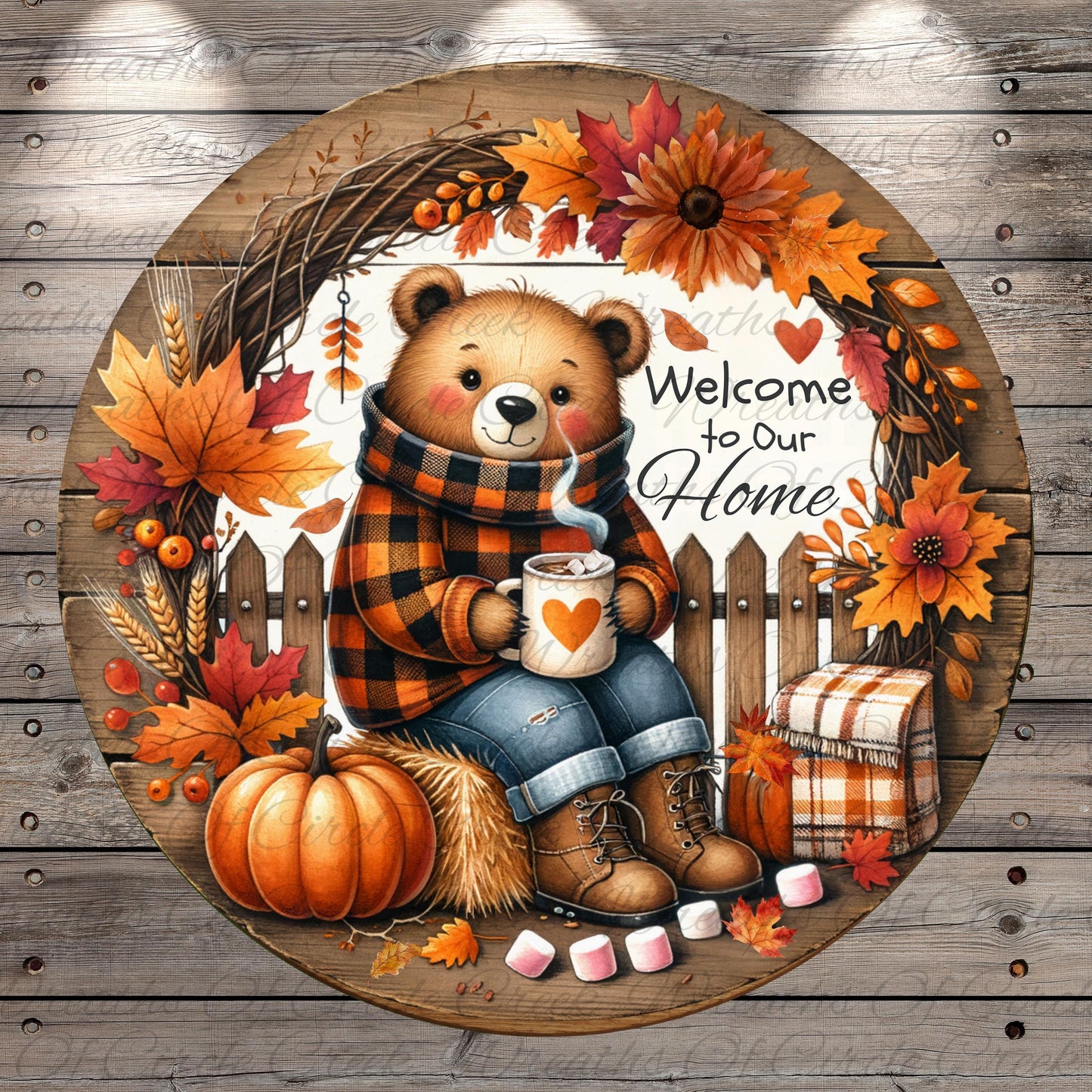 A round wooden sign with a teddy bear sitting on a bench, holding a mug and surrounded by autumn decorations such as leaves, flowers, and a pumpkin.