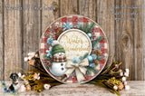 A decorative wreath with a snowman and winter-themed elements, including pine cones, flowers, and a bow, is displayed on a wooden surface.