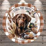 A brown dog is depicted in the center of the image, surrounded by a duck and reeds, with the text "I CALL THE SHOTS" written above the dog.