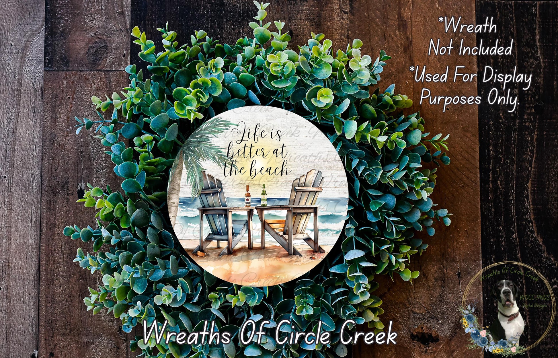 a wreath with a tropical beach scene, including a table and chairs, surrounded by lush greenery. The wreath is displayed on a wooden surface, and there is a text overlay that reads "Life is better at the beach" and "Wreaths of Circle Creek".