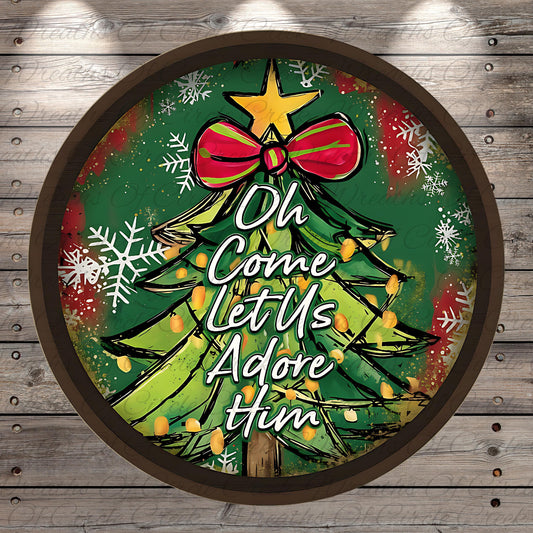 A circular Christmas tree decoration with a bow and snowflakes, surrounded by the text "Oh Come Let Us Adore Him"