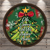 A circular Christmas tree decoration with a bow and snowflakes, surrounded by the text "Oh Come Let Us Adore Him"