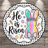 A round decorative Easter-themed design featuring a bunny, flowers, eggs, and a bow.