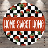 a circular design with a black and white checkered pattern and a repeating pattern of red strawberries. The text "HOME SWEET HOME" is prominently displayed in the center of the design.