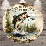 A large circular image depicting a fish jumping out of the water, with a person fishing in the background, surrounded by a forest and a lake. The text "Life is better at the lake" is prominently displayed above the fish.