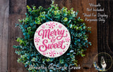A wreath made of green leaves and pink candy canes, with the text "Merry & Sweet" written on it.