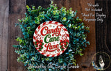 a wreath made of green leaves and red and white candy canes, with the text "Candy Canes Lane" displayed on the wreath.