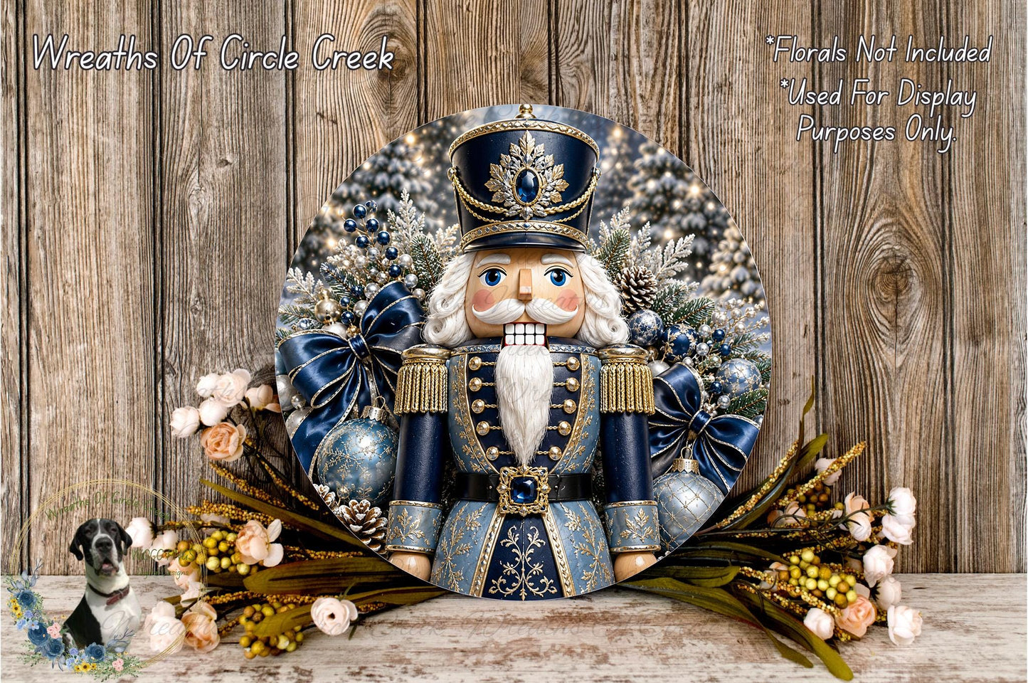 A nutcracker figure surrounded by a wreath of blue and gold ornaments, pine cones, and flowers, set against a wooden background.