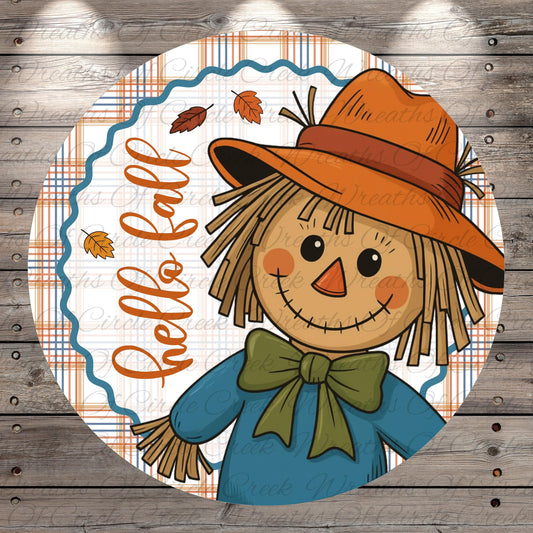 A cheerful scarecrow wearing a hat and bowtie, surrounded by autumn leaves, with the text "Hello fall" written around it.