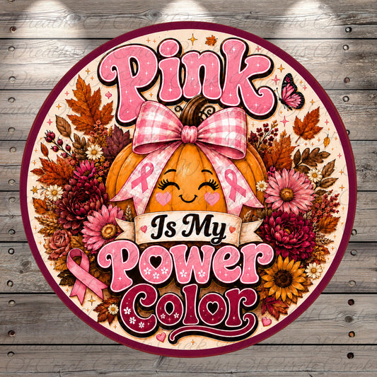 The image is a round sign with a pumpkin and flowers, surrounded by a ribbon and the text "Pink Is My Power Color".