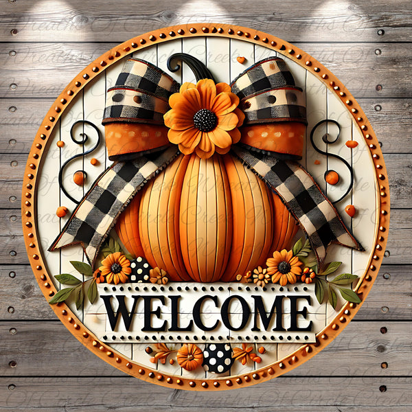 A decorative welcome sign featuring a large orange pumpkin with a bow, surrounded by flowers and leaves, with the word "WELCOME" displayed prominently.