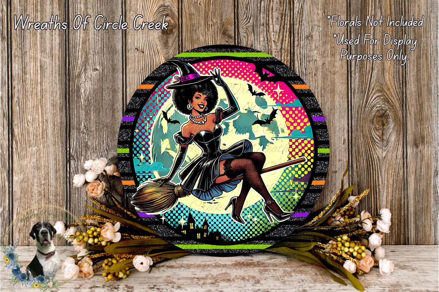 A round, decorative wreath with a woman dressed as a witch, holding a broom, surrounded by flowers and a wooden background.