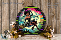 A round, decorative wreath with a woman dressed as a witch, holding a broom, surrounded by flowers and a wooden background.