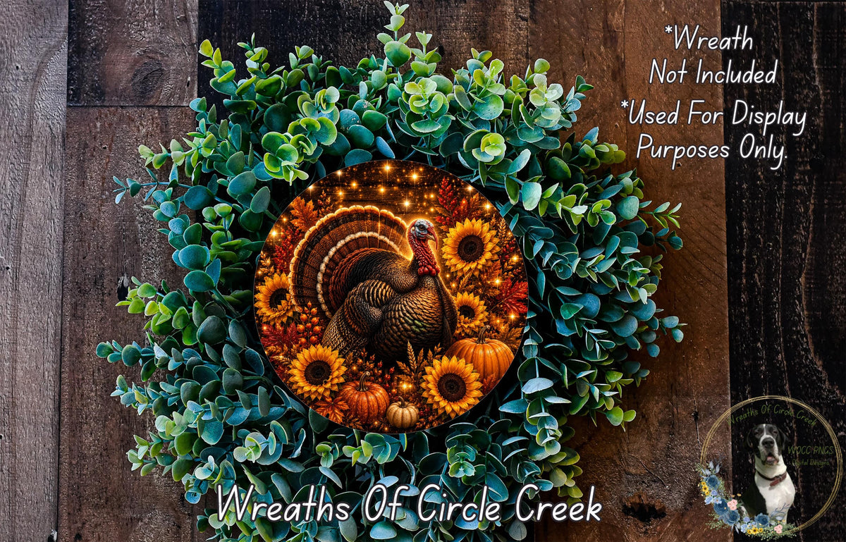 A wreath made of various autumn-themed elements, including a turkey, sunflowers, pumpkins, and greenery, is displayed on a wooden surface.