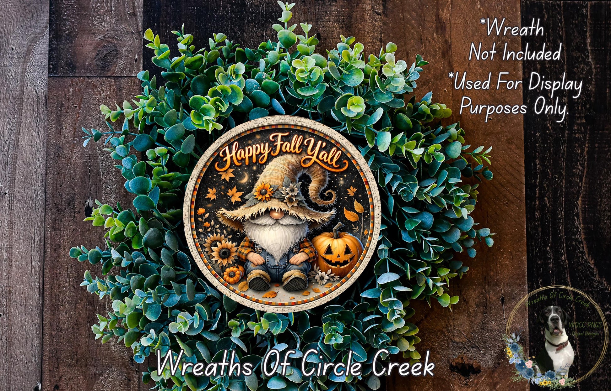A wreath made of green leaves and a gnome wearing a hat with the text "Happy Fall Yell" on it, placed on a wooden surface.