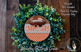 a wreath made of green foliage and a football, with the text "game day" prominently displayed on the wreath.