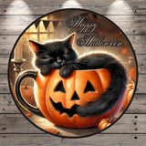 A black cat is curled up and sleeping inside a carved pumpkin, surrounded by other pumpkins and a candle, with the text "Happy Halloween" displayed above the pumpkin.