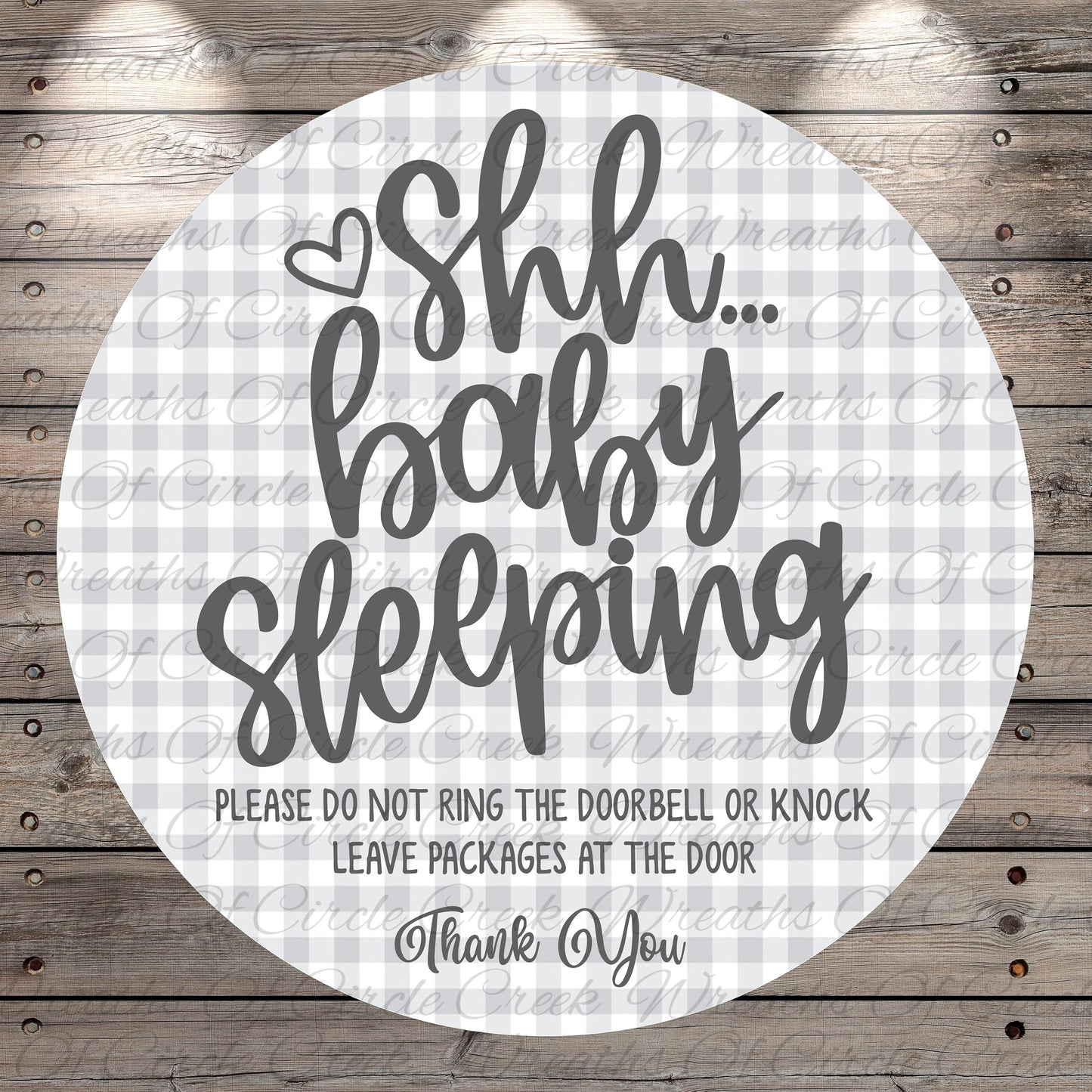 a circular sign with a message that says "Shh baby sleeping" in a playful, humorous font. The sign also includes a warning that says "Please do not ring the doorbell or knock. Leave packages at the door. Thank You."