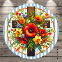 A vibrant floral arrangement with red poppies, yellow daffodils, and orange and yellow flowers is displayed on a wooden background.