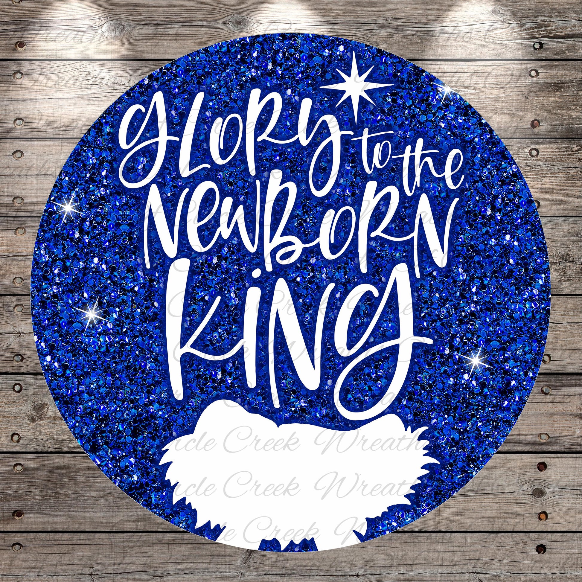 A circular graphic with a glittery blue background and the text "Glory to the Newborn King" written in white.