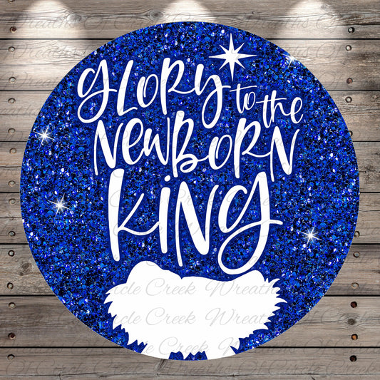 A circular graphic with a glittery blue background and the text "Glory to the Newborn King" written in white.