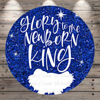 A circular graphic with a glittery blue background and the text "Glory to the Newborn King" written in white.