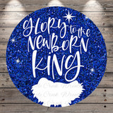 A circular graphic with a glittery blue background and the text "Glory to the Newborn King" written in white.