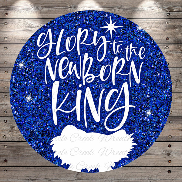 A circular graphic with a glittery blue background and the text "Glory to the Newborn King" written in white.