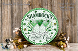 a circular sign with the text " Shamrock's Cocktail Club" and three martini glasses with shamrocks, surrounded by flowers and greenery.