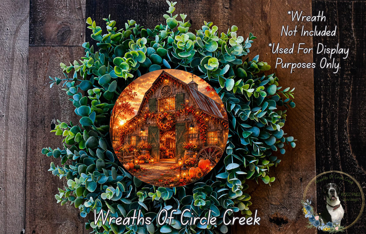 A wreath made of green leaves and a circular image of a rustic barn with a warm, autumnal glow.