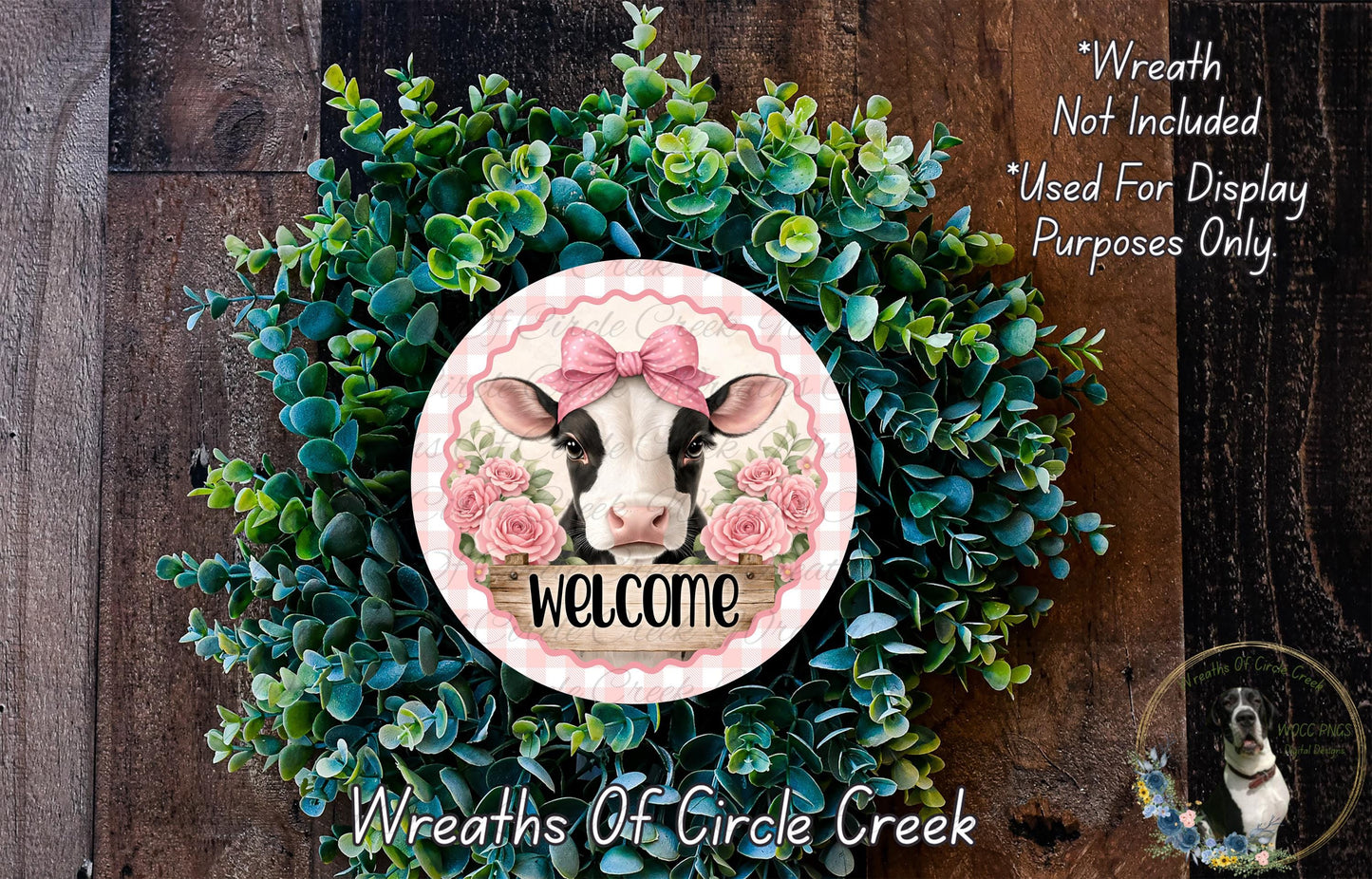 a wreath with a cow's head and the word "Welcome" written on it, surrounded by green foliage.