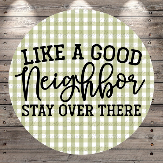 a circular design with a green and white checkered pattern. The design has the text "LIKE A GOOD NEIGHBOR STAY OVER THERE" written in a stylized font.