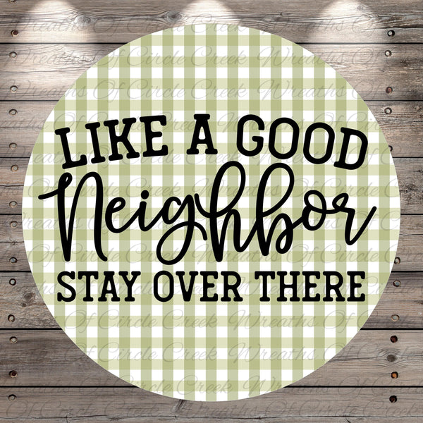 a circular design with a green and white checkered pattern. The design has the text "LIKE A GOOD NEIGHBOR STAY OVER THERE" written in a stylized font.