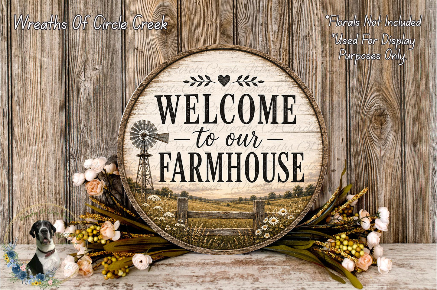 a wooden sign with the text "Welcome to our Farmhouse" and a windmill illustration, surrounded by a wreath of flowers and a wooden fence.