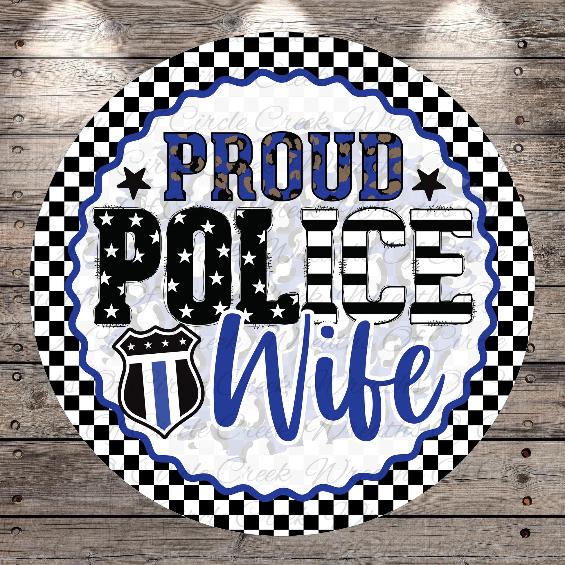 a circular design with a checkered border and a police officer's badge symbol. The text "Proud Police Wife" is prominently displayed in the center of the design.