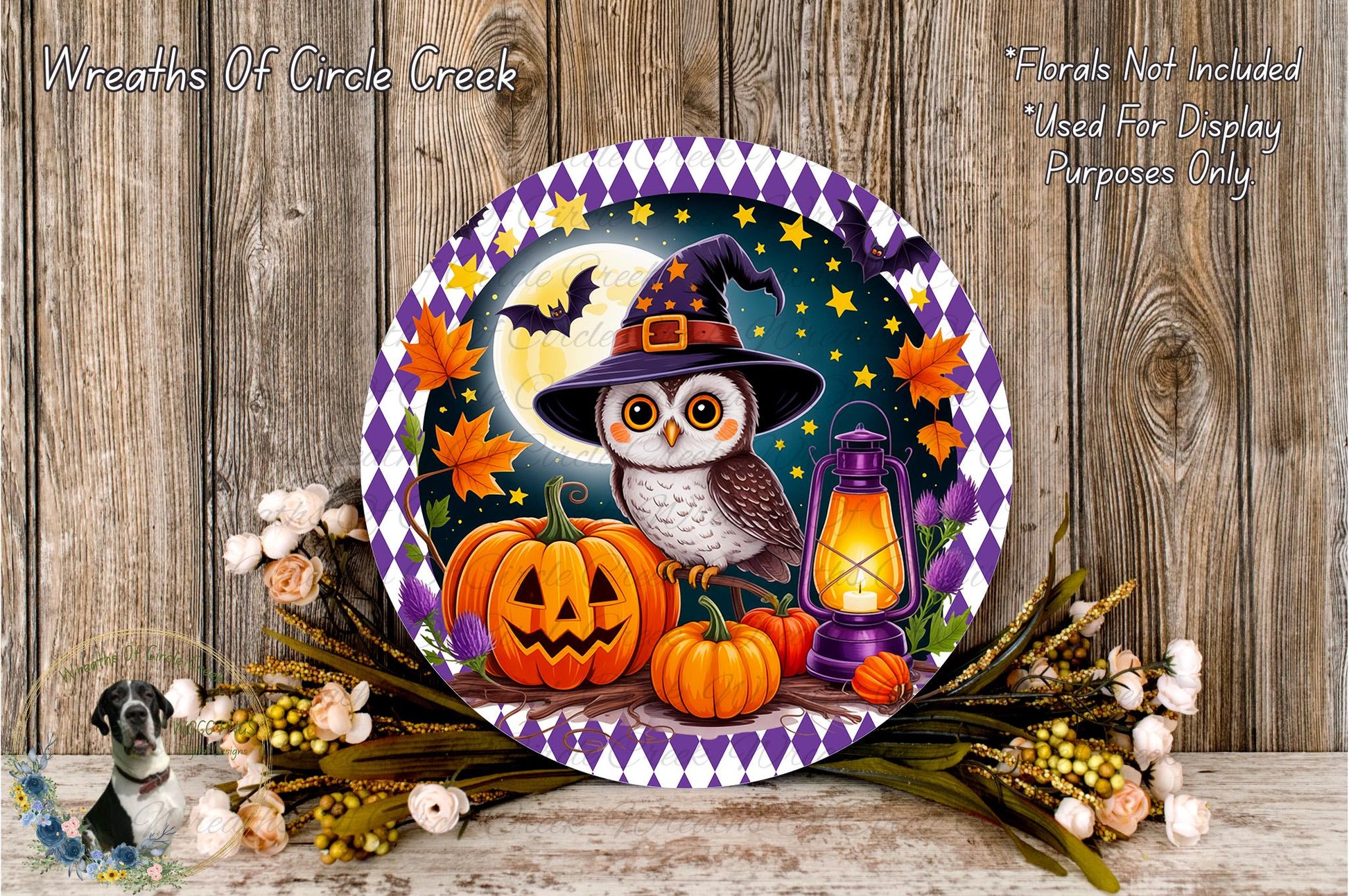 A Halloween-themed wreath featuring an owl wearing a witch's hat, surrounded by pumpkins, a lantern, and autumn leaves, set against a night sky background.