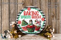 A decorative sign with the text "Baking Spires Bright" and illustrations of a snowman, cupcakes, and a Christmas tree, surrounded by a wreath of flowers and greenery.