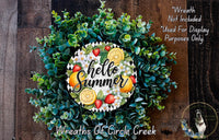 A wreath made of various green plants and fruits, including oranges, strawberries, and lemons, with the text "Hello Summer" displayed on it.