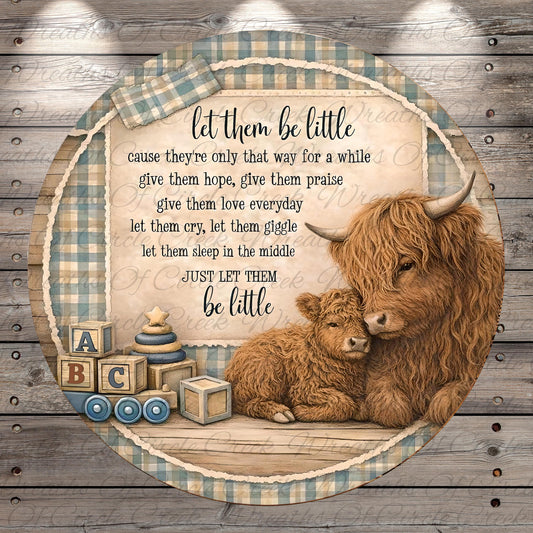 a mother cow and her baby cow, with a wooden background and a decorative border. The mother cow is sitting on a wooden surface, and the baby cow is lying down next to her. The image also includes a message that reads "let them be little cause they're only that way for a while give them hope, give them praise let them love everyday let them cry, let them laugh let them sleep in the middle just let them be little".