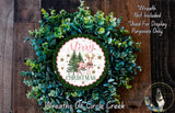 A Christmas wreath made of evergreen branches and a circular sign with the text "Merry Christmas" and a deer image.