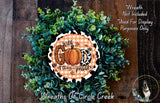 A wreath made of green leaves and a pumpkin, with a decorative sign that says "With God all things are possible".