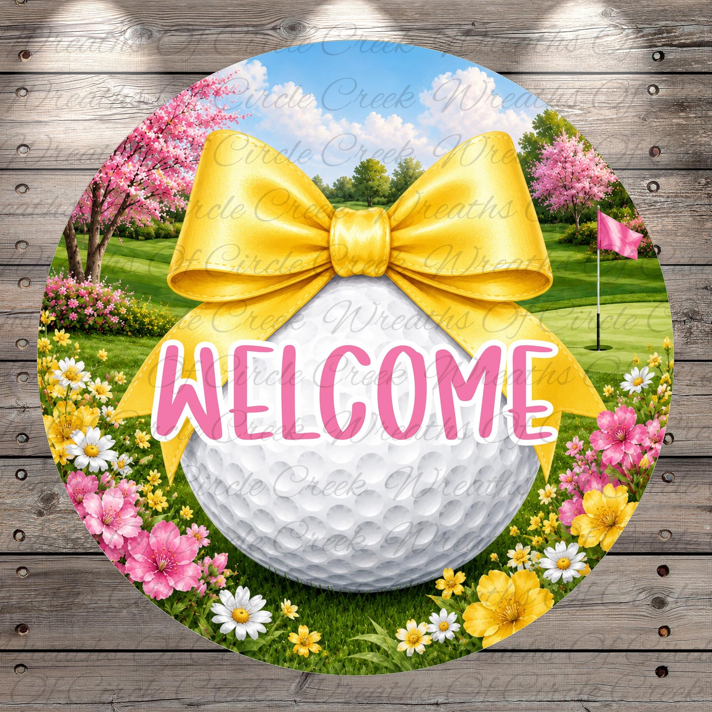 A round sign with a golf ball, a yellow ribbon, and a bow, surrounded by colorful flowers and a grassy field with trees. The sign has the word "WELCOME" written on it.