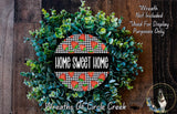 a wreath made of green leaves and red berries, with the text "Home Sweet Home" displayed prominently in the center.