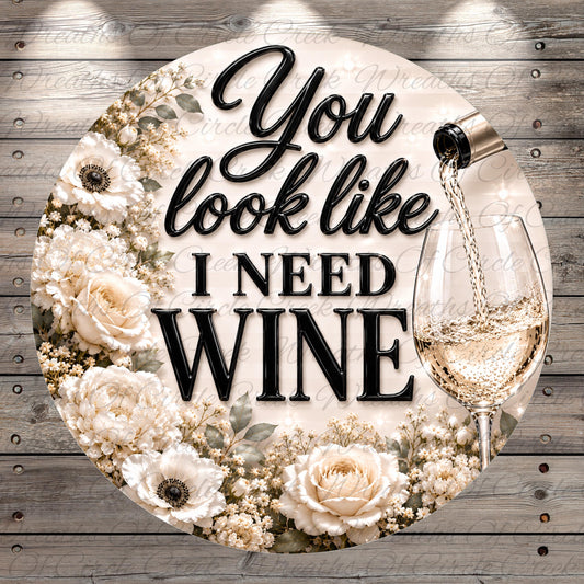 a decorative floral design with a wine glass and the text "You look like I need wine" prominently displayed.