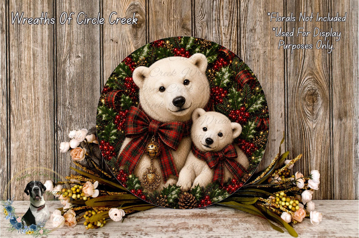 A round wreath with two white teddy bears wearing plaid bows, surrounded by pine cones, berries, and flowers, placed on a wooden surface.