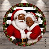 Santa Claus and his grandmother are depicted in a festive holiday scene, surrounded by a wreath of holly and berries.