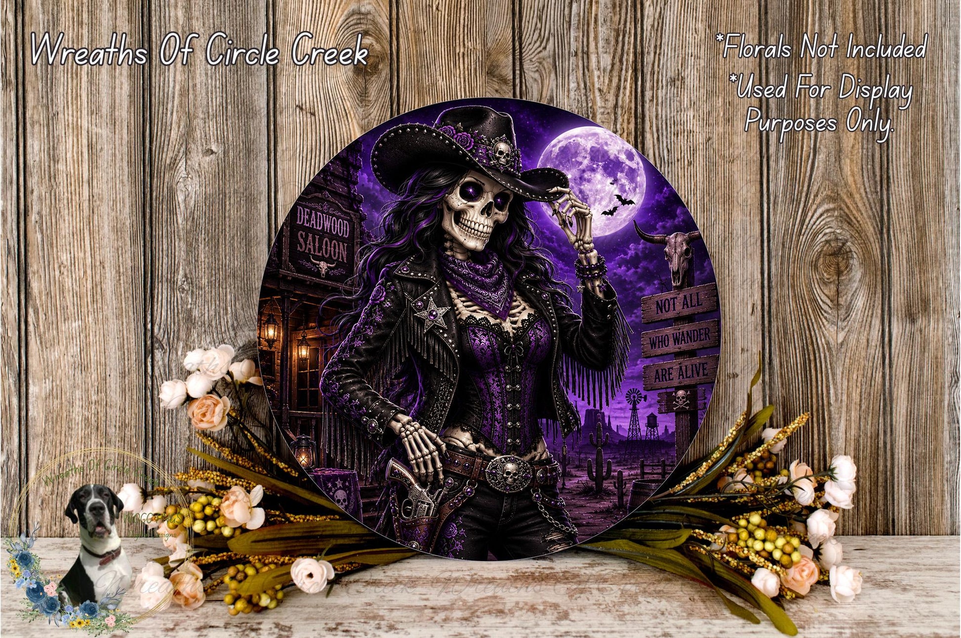 a skull wearing a cowboy hat and holding a gun, surrounded by flowers and a sign that reads "Deadwood Saloon".