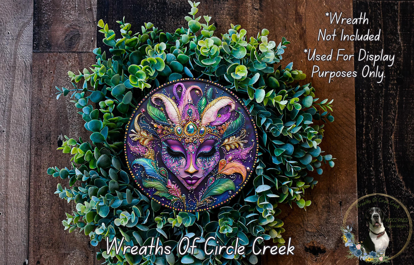 A wreath made of green leaves and flowers, with a colorful face design in the center.