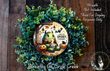 A wreath made of green leaves and a carved pumpkin, featuring a cartoon monster with a friendly expression and the text "Hello Spooky Season!"